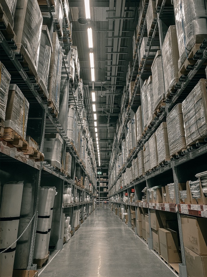 Modern warehouse aisle with organised product storage for supply coordination.