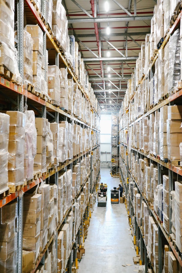 Organised warehouse shelving with packaged goods ready for industrial supply coordination.