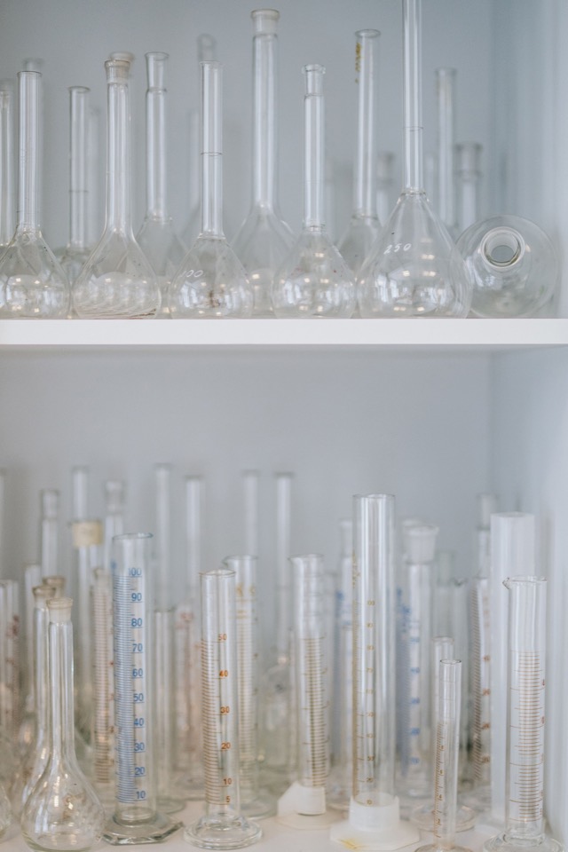 Neatly arranged laboratory glassware representing careful enquiry review.